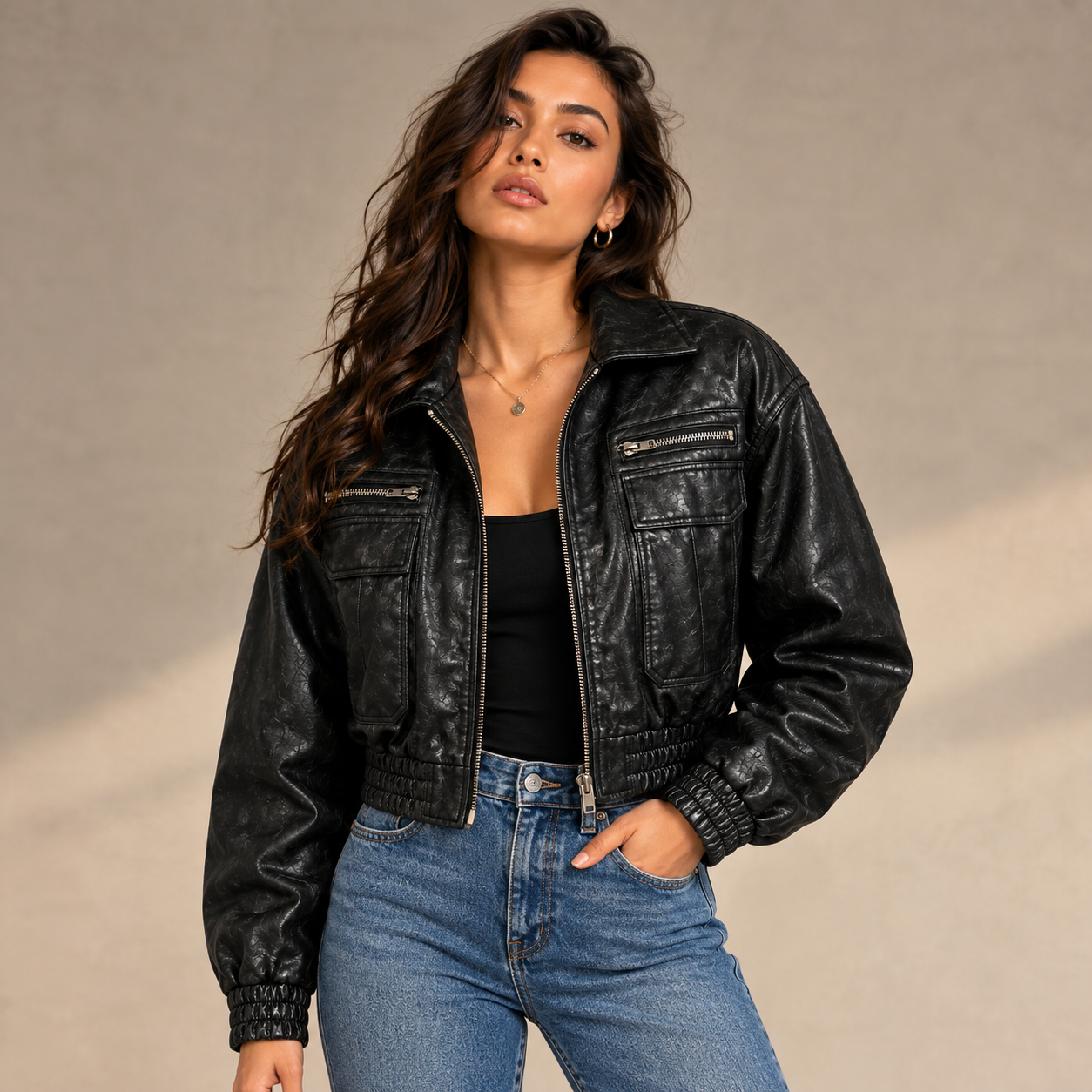 Female model wearing women’s black leather bomber jacket